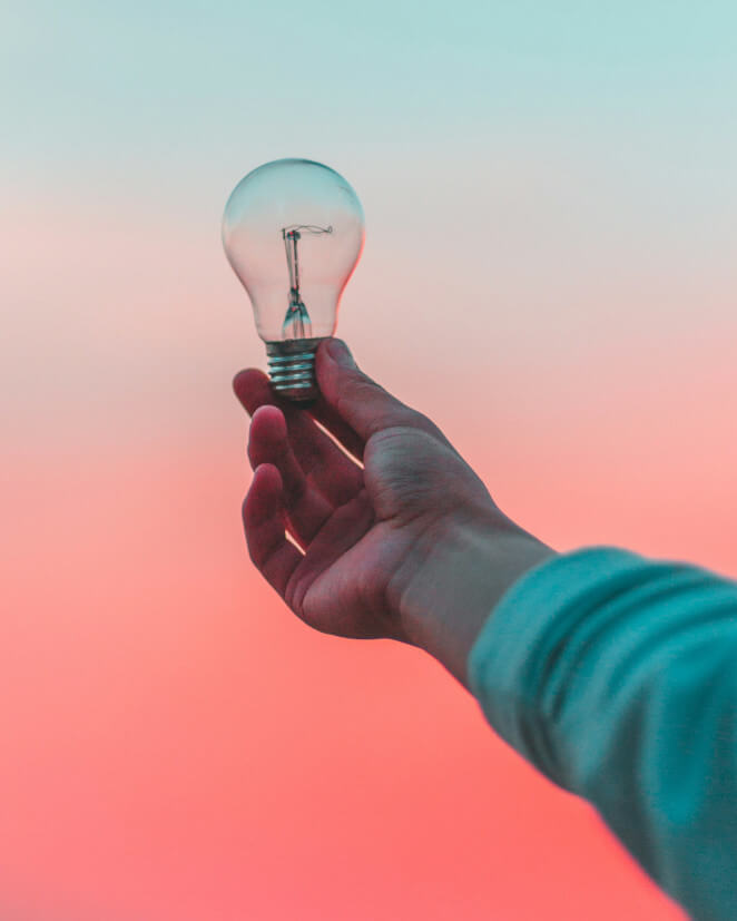 Hand holding lightbulb